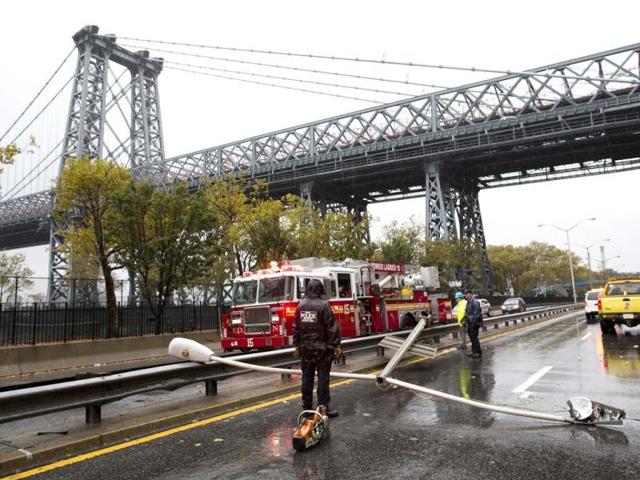 Police and firefighters respond to a downed street light on FDR drive in New York as Hurricane Sandy continued on its path forcing a shutdown of mass transit. AP Photo