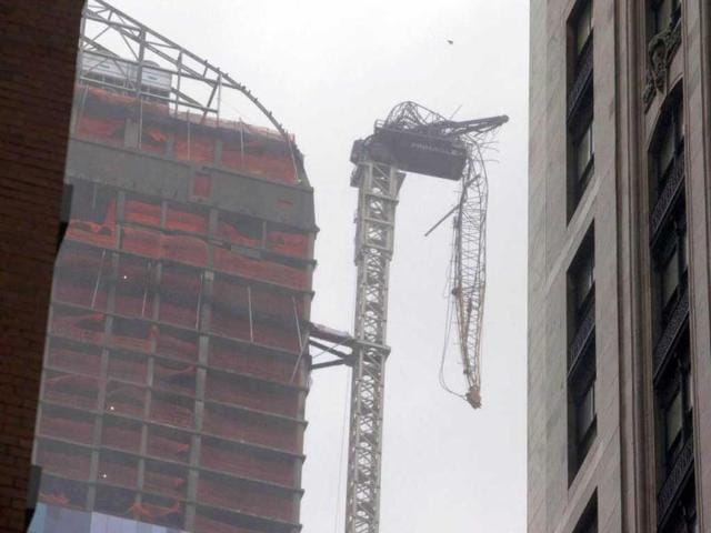 A collapsed crane dangles beside a building under construction, as superstorm Sandy made its approach, in New York. Reuters photo
