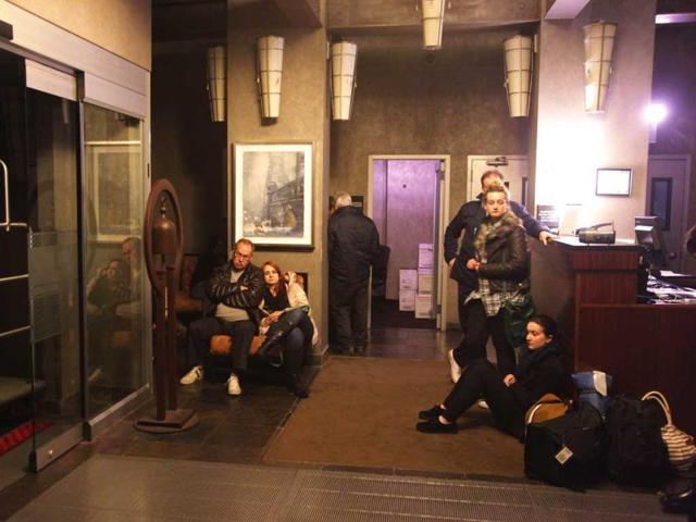 People wait in the lobby of the Hampton Inn Manhattan-SoHo after the power went out in New York City. AFP