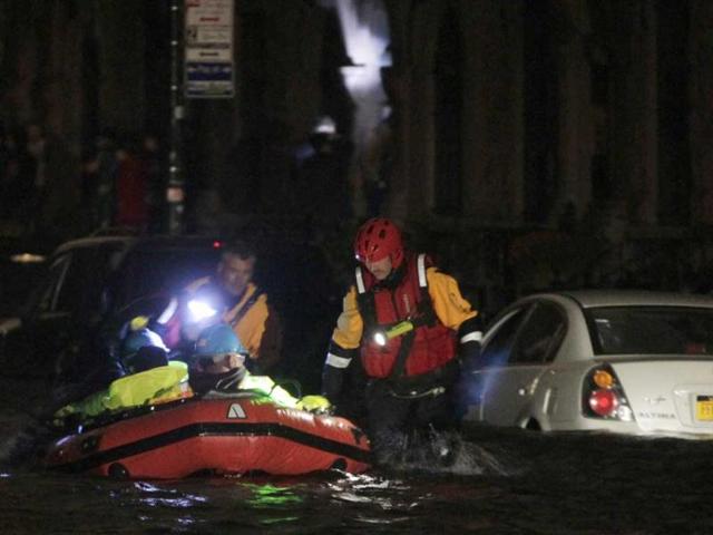 FDNY fire and rescue personnel lead a boat of ConEd power workers through flood waters after their power station was over fun by flood waters in New York. Reuters photo