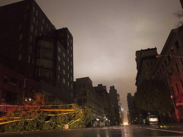 A fallen tree lays along a darkened Sixth Avenue in Chelsea during a blackout believed to be caused by rising river waters as superstorm Sandy made its approach in New York. Reuters photo