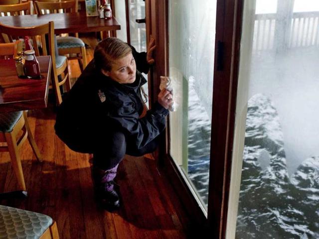 Angelique Hionis cleans up after flooding occurred at Bubba's Seafood Restaurant and Crabhouse due to the effects of wind and rain from winds of superstorm Sandy in Virginia Beach, Virginia. Reuters photo