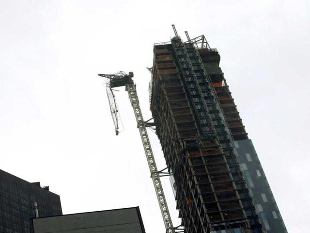 A crane hangs from a building after being damaged in winds from superstorm Sandy in New York. Reuters photo