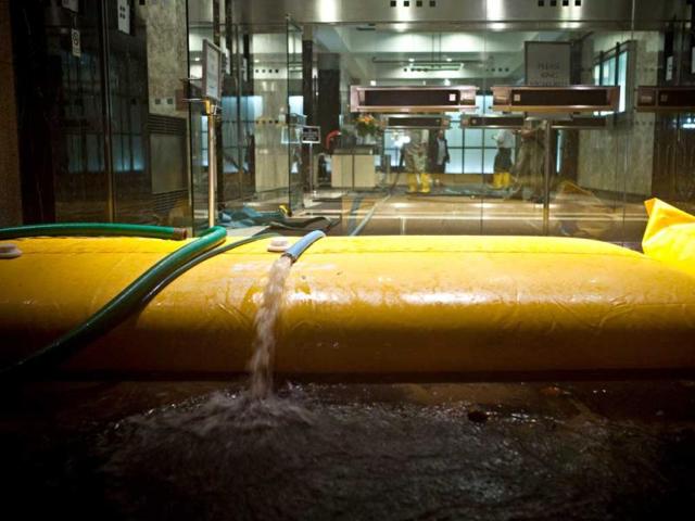 Flood water is pumped out of a building during the landfall of superstorm Sandy in the Financial District of New York, United States. AFP photo