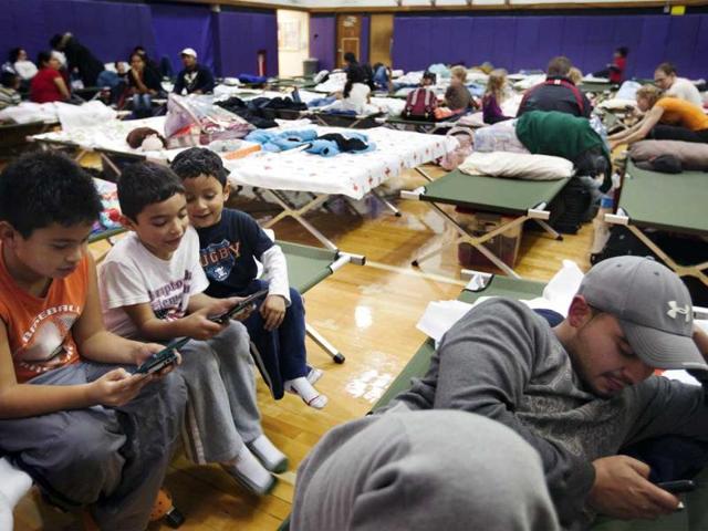 Young boys play video games while in the sleeping area of a Red Cross shelter in Hampton Bays, New York. Reuters photo
