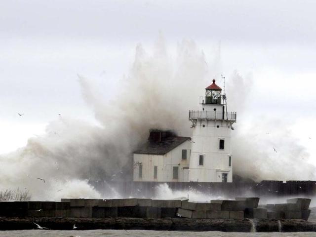 Waves pound a lighthouse on the shores of Lake Erie near Cleveland. AP Photo