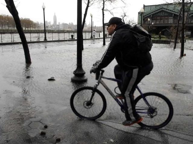 A man rides his bike through a flooded Erie-Lackawanna Park after superstorm Sandy in Hoboken, New Jersey. AFP photo