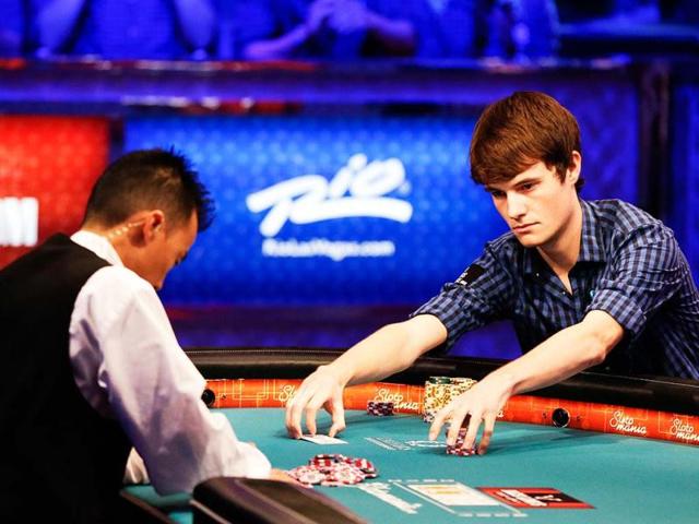 Jake Balsiger pulls in the pot after winning a hand during the World Series of Poker final table in Las Vegas. AP Photo/Julie Jacobson