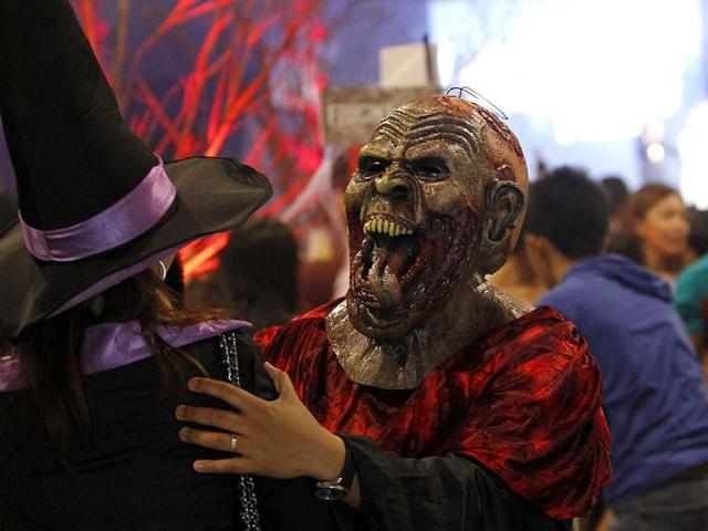 A man with a mask joins Halloween celebration at a mall in Manila. REUTERS/Cheryl Ravelo