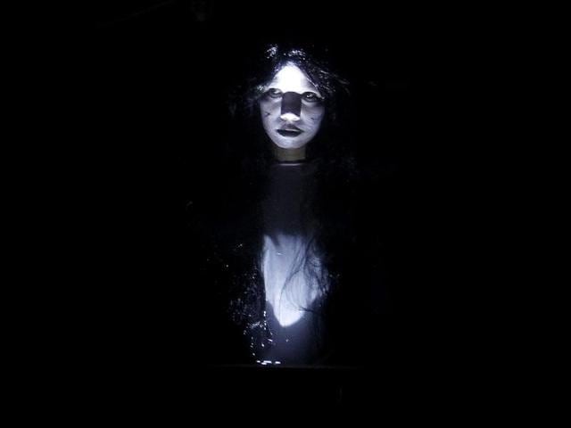 An actress dressed as a ghost scares people entering a "haunted school" during a Halloween celebration at a mall in Manila. REUTERS/Cheryl Ravelo