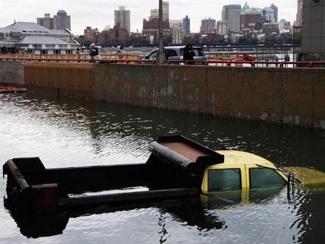 A truck from the New York City Department of Transportation is submerged at the entrance to the Battery Park Underpass in lower Manhattan. AP Photo/Mark Lennihan