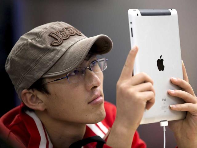 A-customer-tries-out-an-iPad-at-an-Apple-Store-in-Beijing-Apple-the-world-s-most-valued-company-has-announced-new-top-executives-to-lead-it-AP-Photo-Andy-Wong
