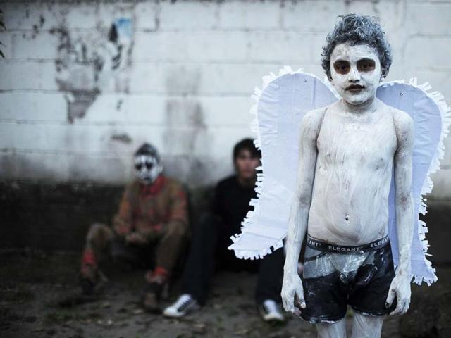 A young reveller gets ready to take part in a parade called "La Calabiuza" on the eve of the Day of the Dead in Tonacatepeque, 20 kms (13 miles) north of San Salvador. AFP photo