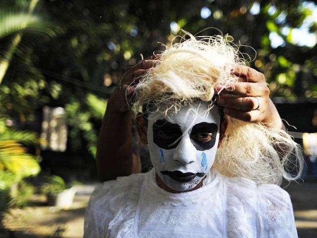 A young reveller gets ready to take part in a parade called "La Calabiuza" on the eve of the Day of the Dead in Tonacatepeque, 20 kms (13 miles) north of San Salvador. AFP photo