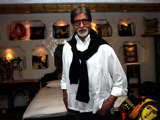 Big B poses in front of the art pieces on display at an exhibition in Mumbai.