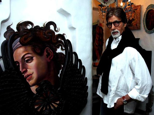 Amitabh Bachchan poses next to a piece on display at an art show in Mumbai.