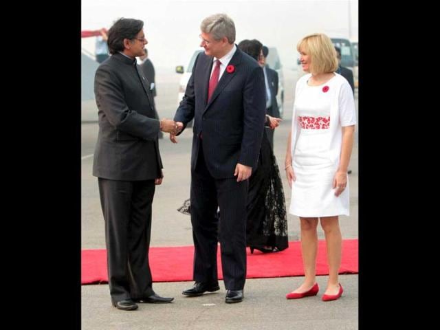 Canadian Prime Minister Stephen Harper being welcomed by Shashi Tharoor, Minister of State for HRD on his arrival at AFS Palam in New Delhi. Harper's wife Laureen is also seen. PTI Photo/Subhav Shukla