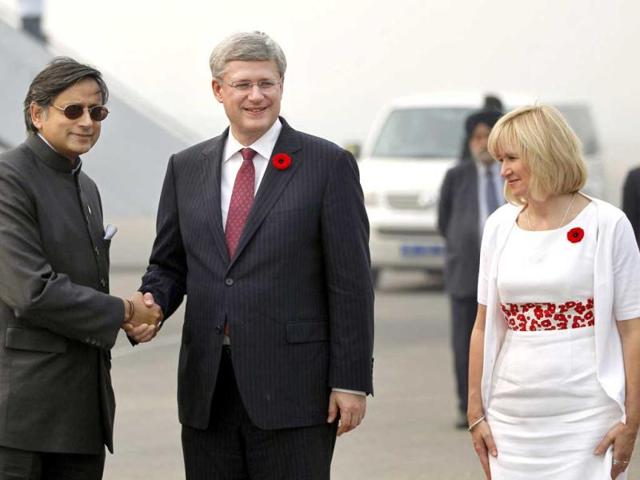 Canada’s Prime Minister Stephen Harper, center, and his wife Laureen Ann, are greeted by Minister of State for Human Resource Development Shashi Tharoor upon their arrival at the Indira Gandhi International Airport in New Delhi. AP Photo/Mustafa Quraishi