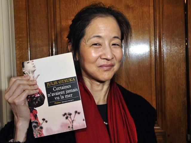 Japanese-born-US-author-Julie-Otsuka-poses-with-her-book-The-Buddha-in-the-Attic-Certaines-n-avaient-jamais-vu-la-mer-on-November-5-2012-in-Paris-Photo-AFP-Mehdi-Fedouach