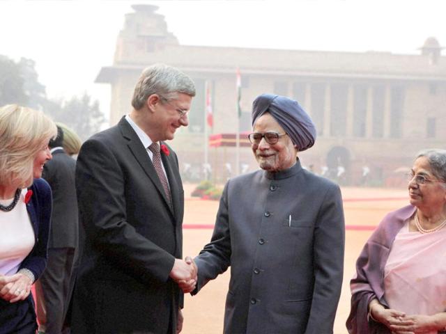 Prime Minister Manmohan Singh shakes hands with his Canadian counterpart Stephen Harper as Harper's wife Laureen Harper, and Singh's wife Gursharan Kaur look on during a ceremonial reception at the forecourt of the Rashtrapati Bhavan in New Delhi. PTI/Vijay Verma