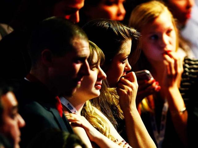 People in attendance react in the crowd while watching election results displayed on a television during Mitt Romney's campaign election night event at the Boston Convention & Exhibition Center in Boston, Massachusetts. AFP