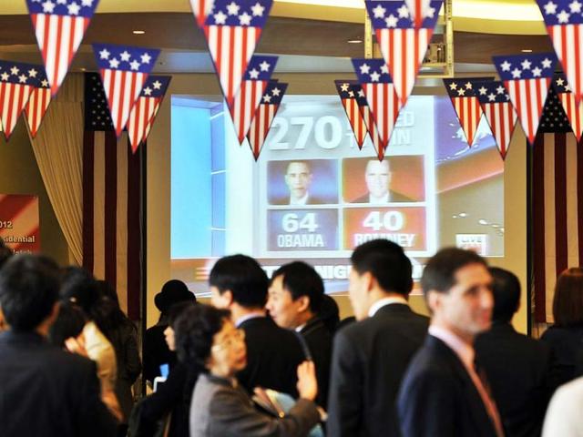 Visitors watch a big screen showing a live broadcast of the US election during a '2012 US Election Watch' event organized by the US embassy in Seoul. AFP photo