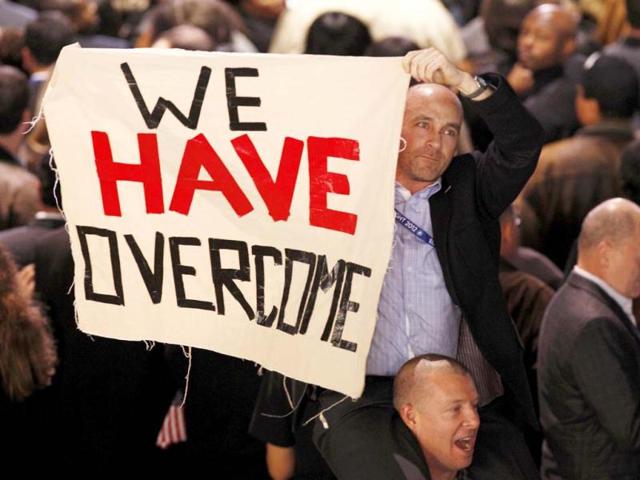 Supporters of US President Barack Obama hold up a sign during his election night rally in Chicago. Reuters