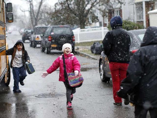 Children run to their parents after leaving the school bus in New Dorp section of the south shore of Staten Island, which was hard hit by Hurricane Sandy in New York City. Reuters/Mike Segar
