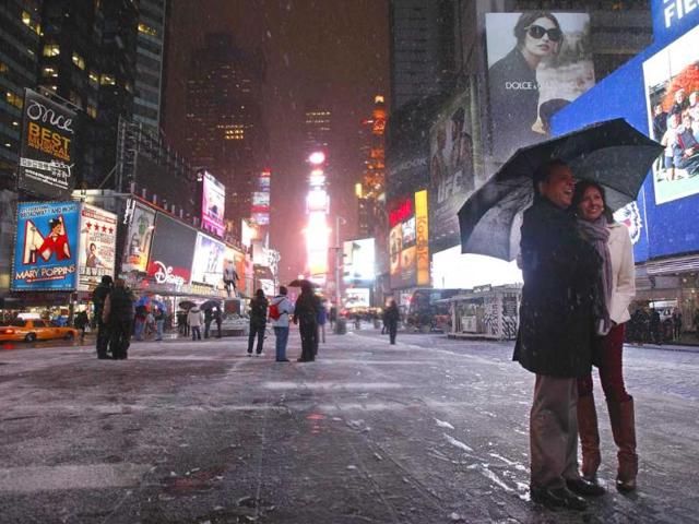 A couple have the picture taken during a snow storm in New York's Times Square. Reuters/Brendan McDermid