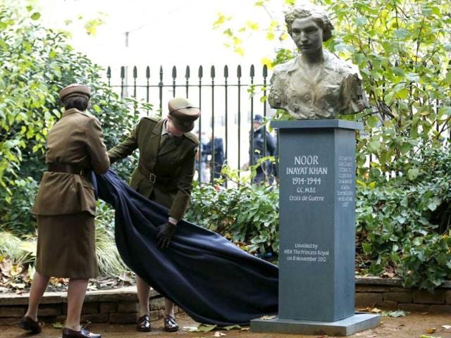 A cloth which covered a bust of Noor Inayat Khan, a British spy captured and killed by the Nazis during World War II, is removed after the statue was unveiled by Britain's Princess Anne in central London. Reuters photo