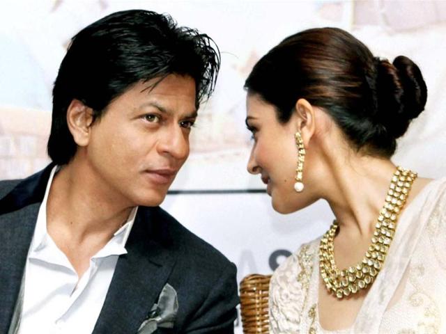 What's cooking? Anushka Sharma whispers into Shah Rukh Khan's ear during the event. (PTI Photo)