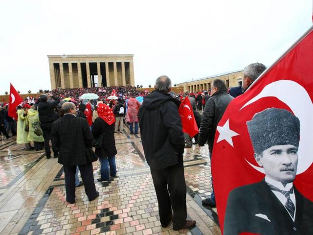 People carry Turkish flags and portraits of Turkey's founder Mustafa Kemal Ataturk as they gather at his mausoleum during a ceremony marking the 74th anniversary of his death in Ankara. AFP/Adem Altan
