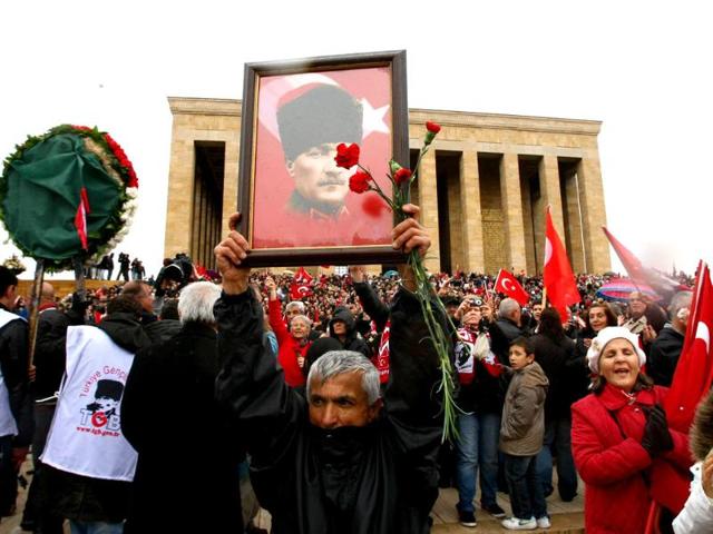 People carry Turkish flags and portraits of Turkey's founder Mustafa Kemal Ataturk as they gather at his mausoleum during a ceremony marking the 74th anniversary of his death in Ankara. AFP/Adem Altan