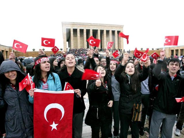 People wave Turkish flags as they gather at the mausoleum of Turkey's founder Mustafa Kemal Ataturk during a ceremony marking the 74th anniversary of his death in Ankara. AFP/Adem Altan