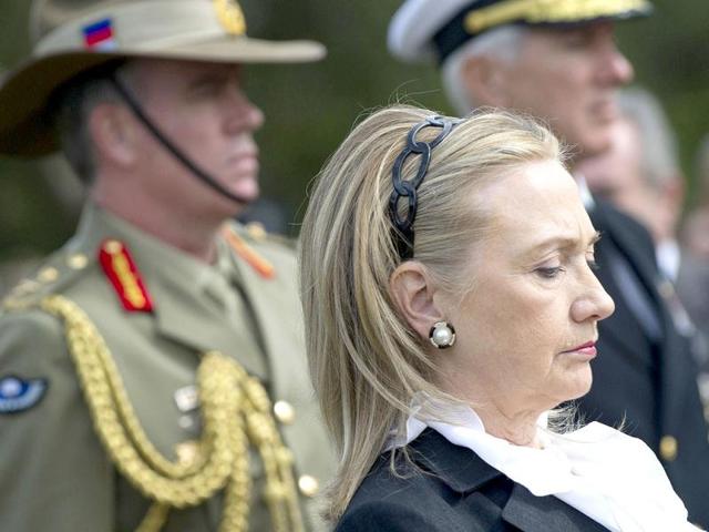U.S. Secretary of State Hillary Clinton looks on during the playing of Taps after participating in a wreath laying ceremony at the State War Memorial, prior to meetings as part of AUSMIN, in Kings Park. (Reuters)