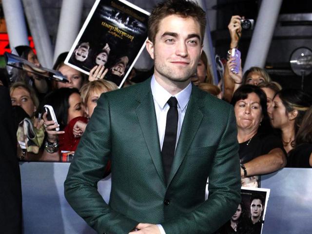 Robert Pattinson looked dapper in a dark-green suit and lavender shirt.
