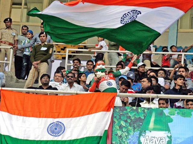 Cricket fans wave the tricolour on the first day of first test match against England at Sardar Patel Motera stadium in Ahmedabad. UNI
