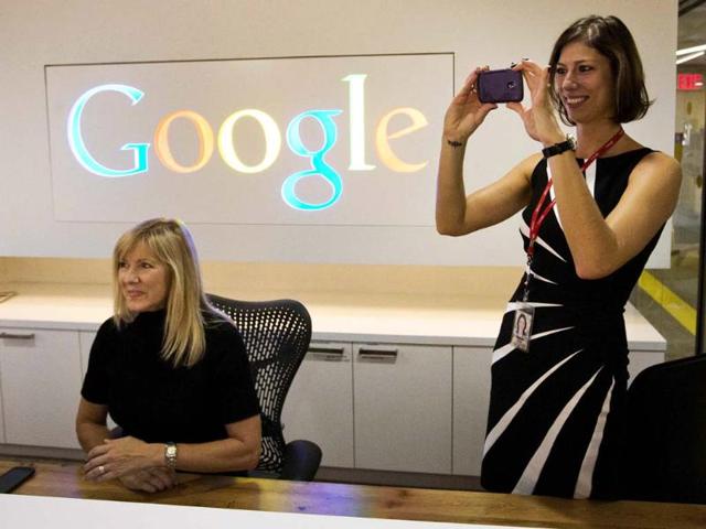 Google-employee-Andrea-Janus-takes-a-picture-with-her-phone-as-her-co-worker-Tracy-McNeilly-looks-on-at-the-new-Google-office-in-Toronto-November-13-2012-Reuters-Mark-Blinch