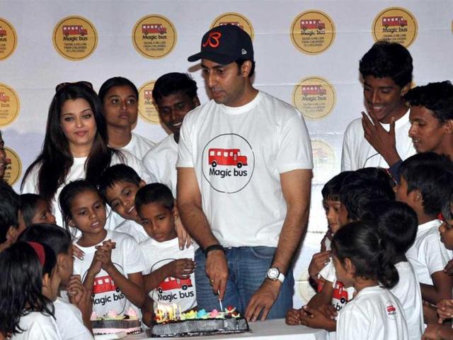 Abhishek Bachchan cuts the cake with the excited kids of Magic Bus NGO.