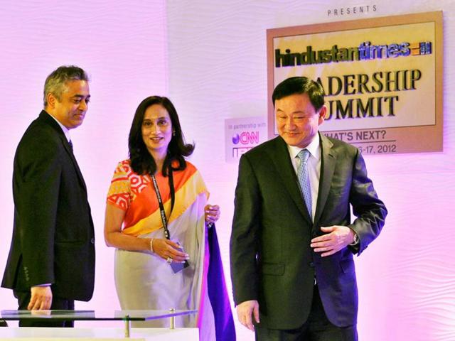 Thailand's former prime minister Thaksin Shinawatra is seen with Shobhana Bhartia, chairperson and editorial director of the Hindustan Times Group, center, and IBN Network 18's Rajdeep Sardesai during the first day of the Hindustan Times Leadership Summit in New Delhi. HT/Gurinder Osan