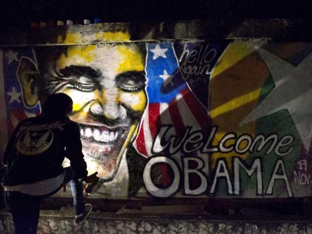 Artist Arker Kyaw paints a graffiti welcoming U.S. President Barack Obama in Yangon, Myanmar. (AP Photo)