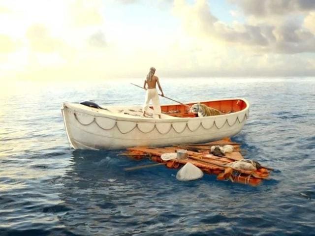 Actor-Suraj-Sharma-R-playing-the-character-Pi-stands-near-a-tiger-named-Richard-Parker-in-a-lifeboat-one-of-the-props-used-in-the-new-film-Life-of-Pi-by-director-Ang-Lee-which-is-yet-to-hit-movie-theatres-Reuters