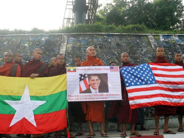 Myanmar Buddhist monks wait to welcome the arrival of U.S. President Barack Obama at Yangon International airport in Yangon, Myanmar. (AP Photo/Khin Maung Win)