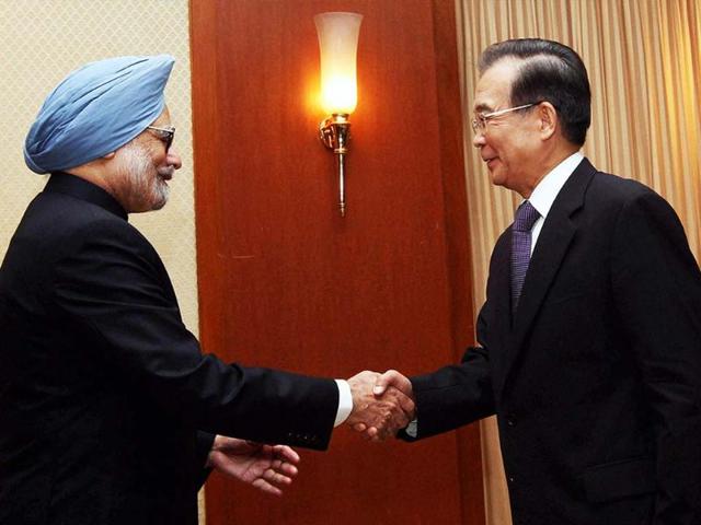 Prime Minister Manmohan Singh shakes hands with Chinese Premier Wen Jiabao during a Bilateral Meeting in Phnom Penh, Cambodia. PTI Photo by Kamal Singh