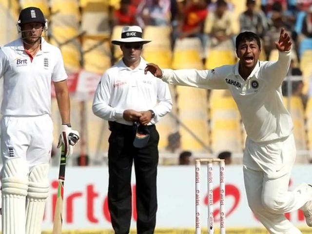 Pragyan Ojha celebrates the dismissal of England's captain Alastair Cook on the last day of the first cricket Test in Ahmedabad. Courtesy BCCI