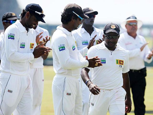 Sri Lanka cricketer Rangana Herath is applauded by teammates as he leaves the pitch at the end of New Zealand's second innings during the third day of the opening Test match between Sri Lanka and New Zealand at the Galle International Cricket Stadium in Galle. AFP/Ishara S Kodikara