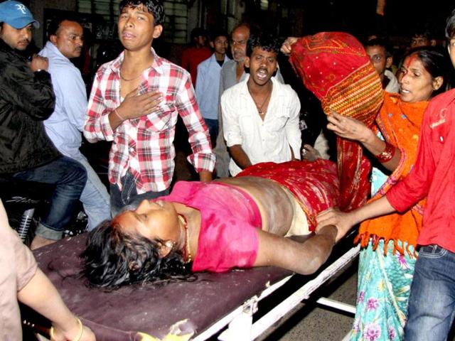 People rush an injured to a hospital in Patna. Many People are feared dead after collapse of a temporary bamboo bridge on Ganga river in the city during the Chhat festival. PTI Photo