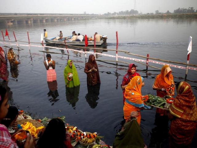 Devotees offer prayers to Lord Sun on the occasion of Chhath Puja at Yamuna ghat in New Delhi. HT Photo/M Zhazo