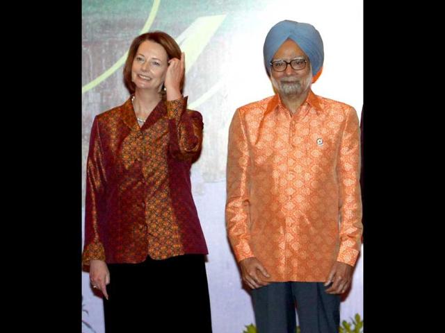 Prime Minister Manmohan Singh and his Australian counterpart Julia Gillard pose for a group photo at the Gala Dinner hosted by Prime Minister of Cambodia Hun Sen ahead of the 10th India-ASEAN Summit in Phnom Penh, Cambodia on Monday. PTI Photo by Kamal Singh