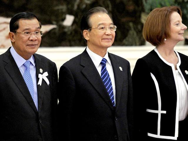 Cambodian Prime Minister Hun Sen, Chinese Prime Minister Wen Jiabao and Australian Prime Minister Julia Gillard stand for a picture ahead of the 7th East Asia Summit in Phnom Penh. AFP